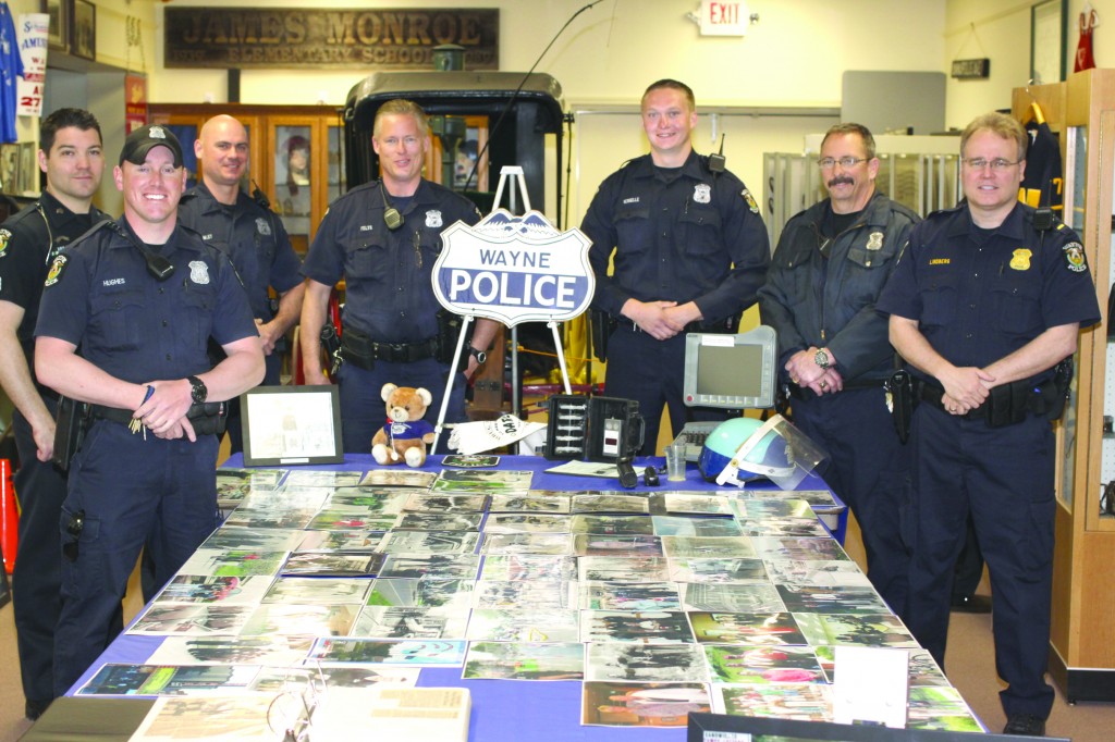 Wayne Police officers check out the Police display at the Wayne Historical Museum featuring photographs of the Wayne Police Department over the years, and the equipment used by the officers. The Museum is open Thursday and Friday 1 p.m. to 4 p.m.  The admission is always free.