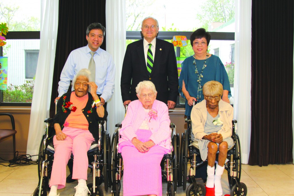 Maple Manor held an Aloha themed birthday party to celebrate the birthdays of three of their residents who were celebrating special milestones. (l-r): Ruby Johnson, 101, Edna Wooten, 102, and Mamie Williams, 102 were joined by Marcus Evangelista, attorney, Mayor Al Haidous and Dr. Stella Evangelista,  administrator and medical director of Maple Manor. Photo by John P. Rhaesa 