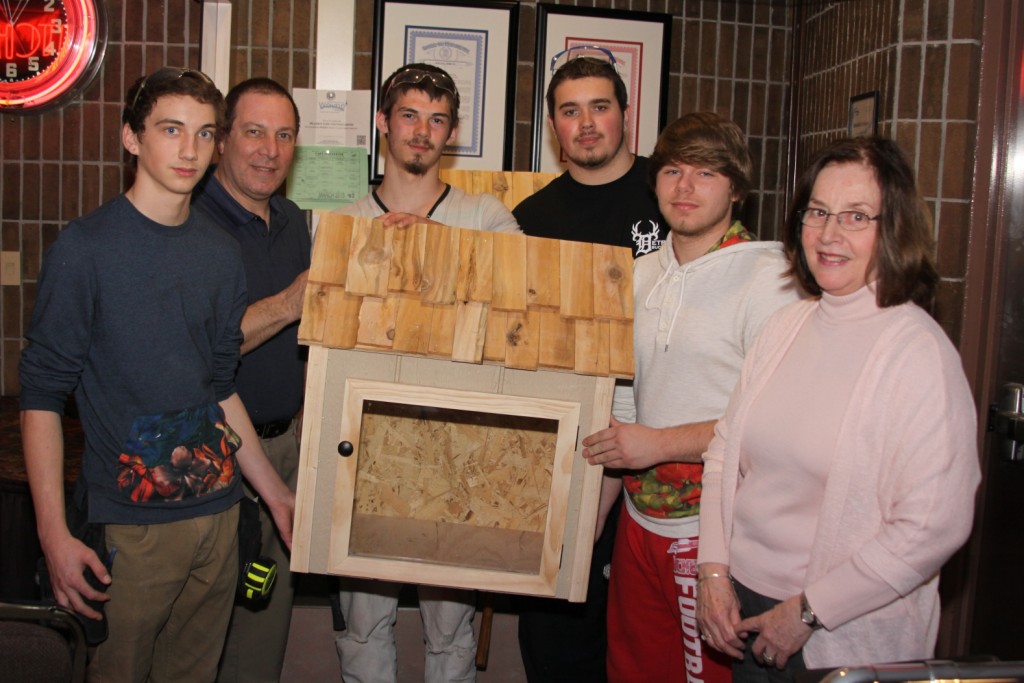 Westland Rotary President Lou Toarmina and Wayne Rotary President Antoinette Wirth receive the Little Free Libraries made by William D. Ford Career Technical Center students Bryan Isaacs, Josh Begarowicz, Kevin Young and Chad Richardson to go out into the community.