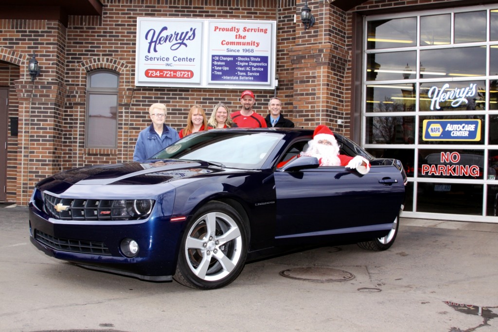 Goodfellows Bev Campbell,  Lisa Bradford, President Jennifer Gietzen, Chris Gietzen, Vice-President Shawn Bell and Santa show off  the 2010 Chevy Camaro to be raffled off at Concerts in the Goudy Park on July 29th. Photo by John P. Rhaesa