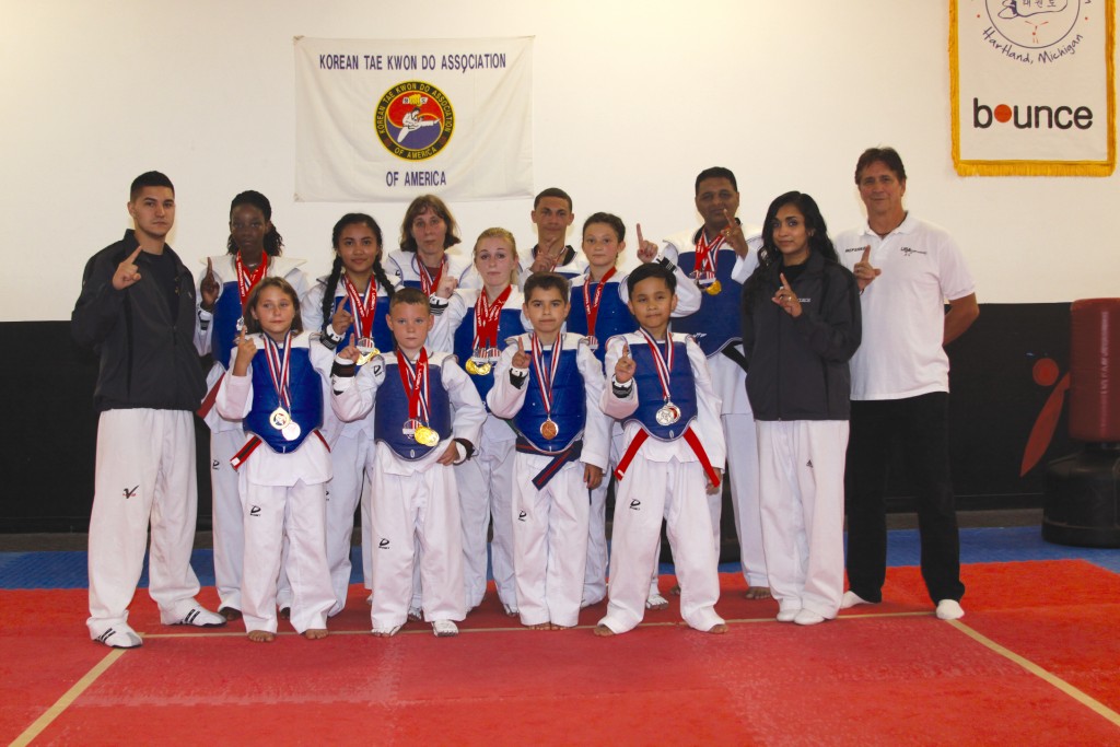 KICKS competition team brought home 10 medals. Front row: Tina Johnson, Alexander Weinberg, Jonathan Floare and Josh Rigor. Back Row: Master Mike Rose, Briahna Kitchen, Cassandra Rigor, Lisa Johnson, Julia Saferian, David Clark II, Aubrey Evans, Gautham Thyagarajan, Master Imali Kent and Grandmaster Ron Rose. Photo by John P. Rhaesa