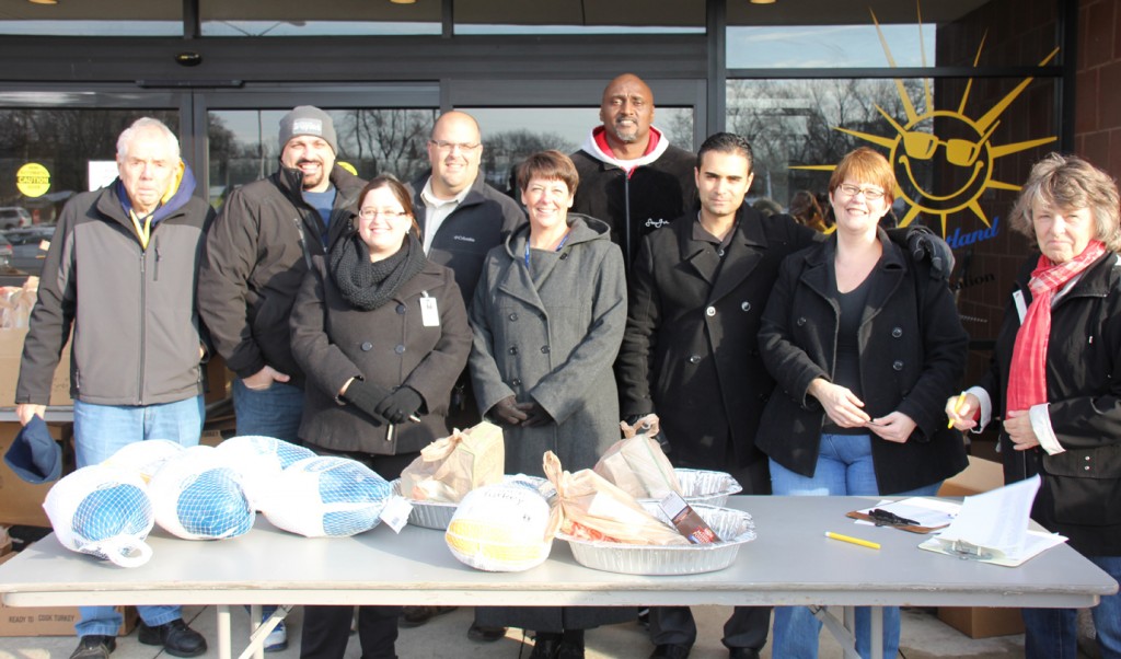 Volunteers L-R: Corky Hayes, Councilman John Rhaesa, Amanda Dybus, Family Resource Center; Brian Haddad; Kelly Bohl, WWCS assistant superintendent,  Ali Sayed, CEO HYPE (front row third from right); Irene Ivanac, HYPE (second from right), Pat Hartford and Jenny Johnson (not pictured) helped pass out the Thanksgiving meals. Photo by Jenny Johnson  