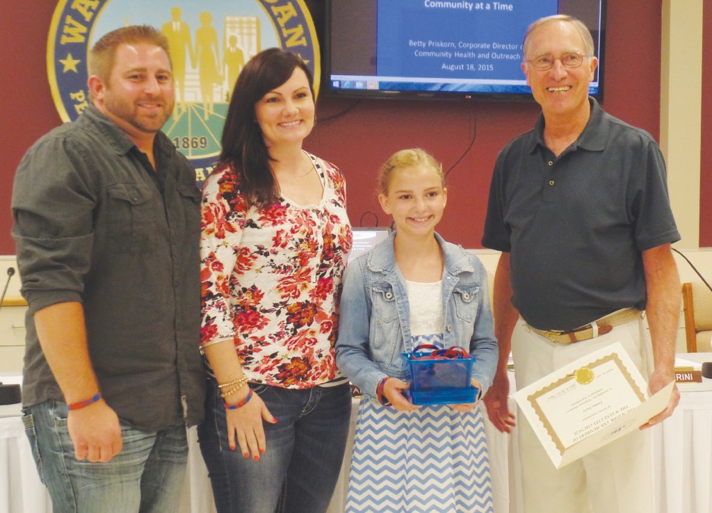 Keith and Teri Socia with their daughter Emma are presented with a cerificate from Mayor James Hawley for her anti-bullying efforts at a City Council meeting earlier this year.