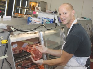 Todd LaCoe shows one on the fresh cuts of meat at Pizmo’s Market.