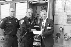 Captain Fred Gilstorff of the Wayne Fire Department, receives a check for $2,500 from Beaumont Hospital Division President Eric W. Widner towards the Jaws of Life. Photo by John Rhaesa