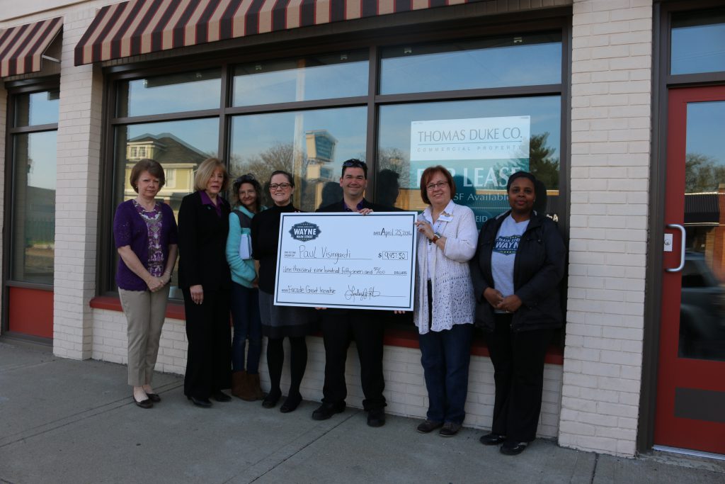 Wayne Main Street Board Members: Treasurer Cynthia Schofield, Pat Rice, secretary and design committee chair Carolyn Marnon, executive director Lindsey Wooten, president Cindee McClure and Theodora Brooks present property owner Paul Visingardi a check for $9,957.50 as the first recipient of the Wayne Main Street Façade Grant Incentive Program. 