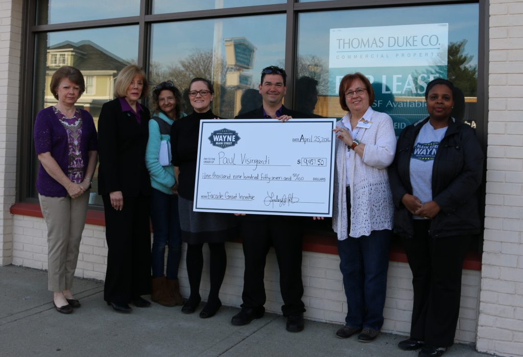 Wayne Main Street Board Members: Treasurer Cynthia Schofield, Pat Rice, secretary and design committee chair Carolyn Marnon, executive director Lindsey Wooten, president Cindee McClure and Theodora Brooks present property owner Paul Visingardi a check for $9,957.50 as the first recipient of the Wayne Main Street Façade Grant Incentive Program. 