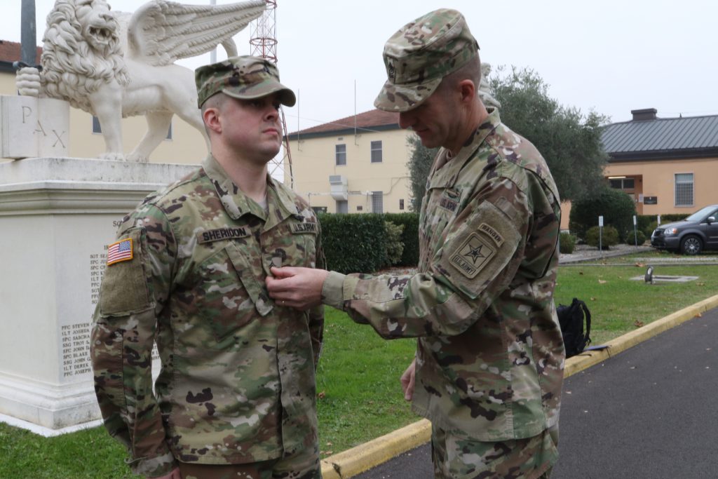 U.S. Army’s most senior enlisted leader, Sgt. Maj. of the Army Daniel Dailey, promotes a junior enlisted Soldier, Spec. James Sheridan, one of U.S. Army Africa’s command drivers, to the rank of Sergeant, Nov. 17, 2016, in front of the USARAF headquarters on Caserma Ederle in Vicenza, Italy. The promotion to sergeant marks a pivotal role change in a Solider’s career from one who is given tasks to one who gives tasks. On this day, Sheridon also celebrates his tenth year of military service, which includes 3-years as active duty and a combined 7-years with Michigan's Army and Air National Guard. (U.S. Army Africa photo by: Staff Sgt. Lance Pounds)